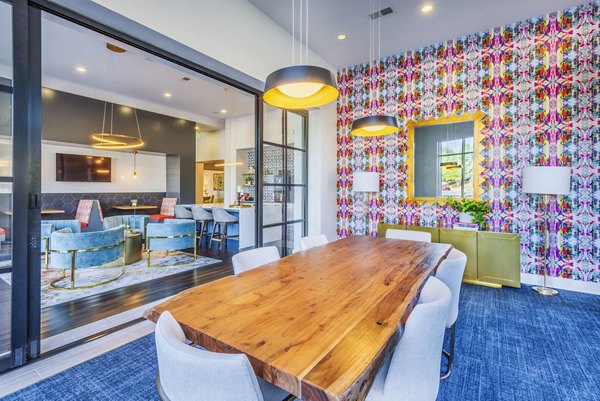 Clubhouse meeting facility featuring modern seating and technology at Presley Uptown Apartments