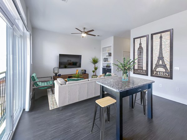 Modern dining and living room with open layout at Presley Uptown Apartments
