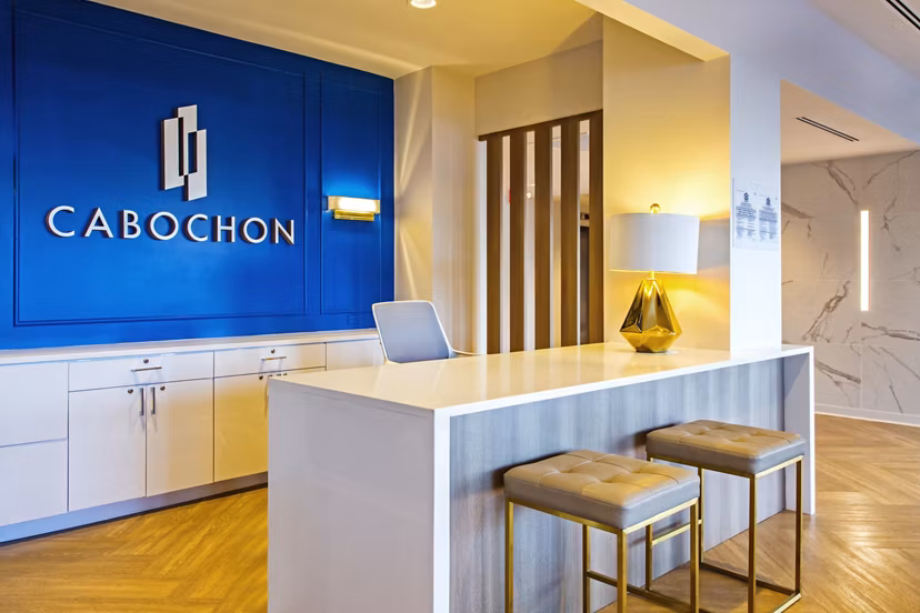 Stylish clubhouse with modern seating and decor at The Cabochon at River Oaks Apartments