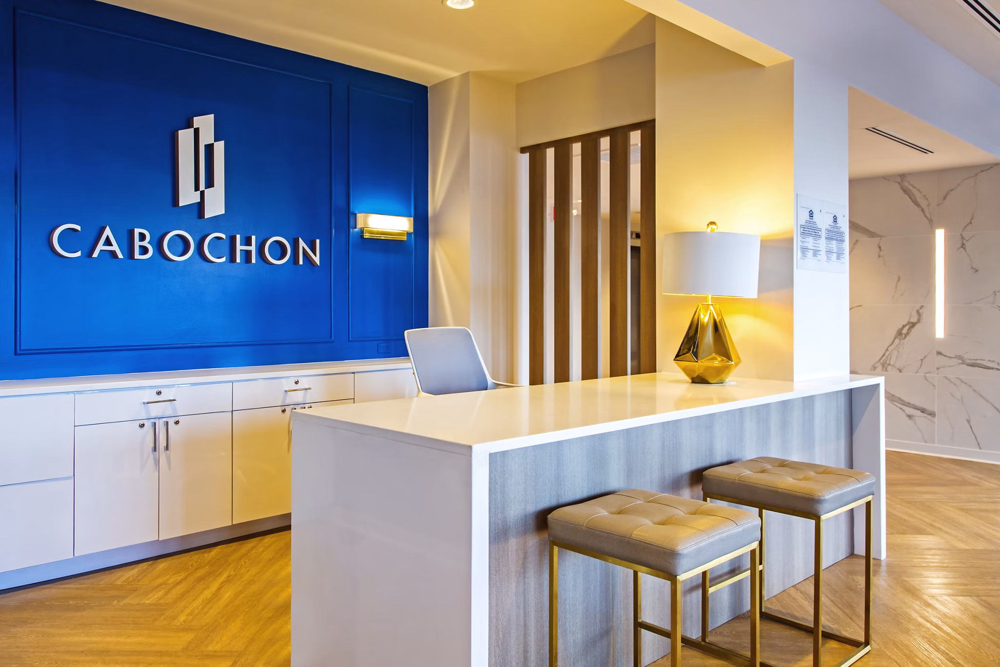 Stylish clubhouse with modern seating and decor at The Cabochon at River Oaks Apartments