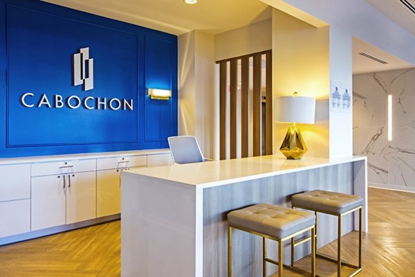 Stylish clubhouse with modern seating and decor at The Cabochon at River Oaks Apartments