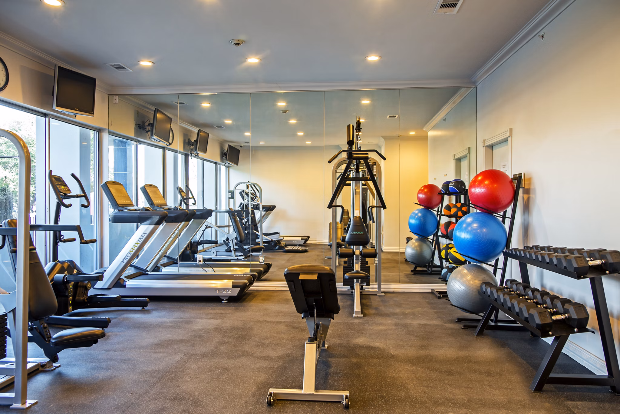 State-of-the-art fitness center featuring modern equipment at The Cabochon at River Oaks Apartments in Houston, TX
