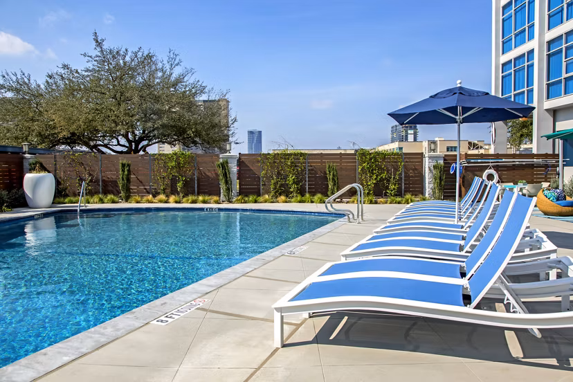 Luxurious pool area at The Cabochon at River Oaks Apartments offering relaxation and scenic views for residents to enjoy