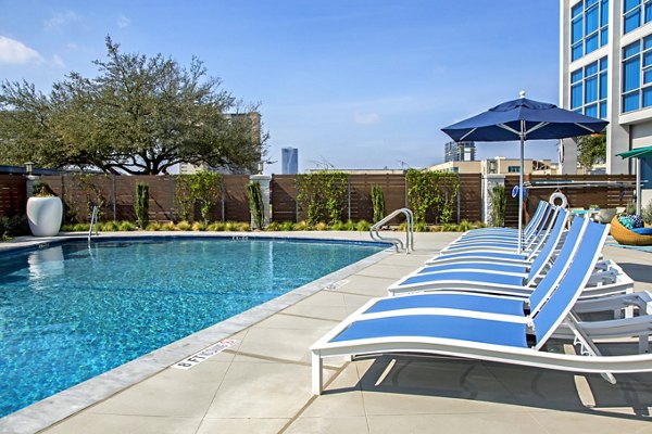 Luxurious pool area at The Cabochon at River Oaks Apartments offering relaxation and scenic views for residents to enjoy