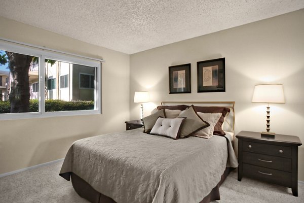 Elegant bedroom featuring expansive windows and modern decor at Madrid Apartments, luxury living by Greystar