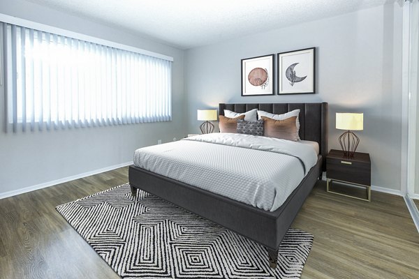 Cozy bedroom with stylish decor and ample natural light at Madrid Apartments, a luxury Greystar property