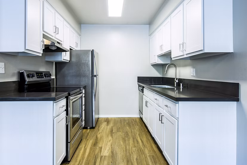 Modern kitchen with stainless steel appliances at Madrid Apartments