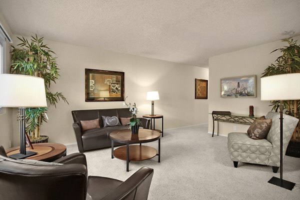 Spacious living room with modern decor and large windows at Madrid Apartments, luxury living by Greystar