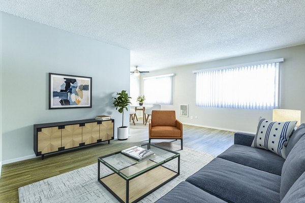 Living room featuring modern decor and cozy seating area in Madrid Apartments
