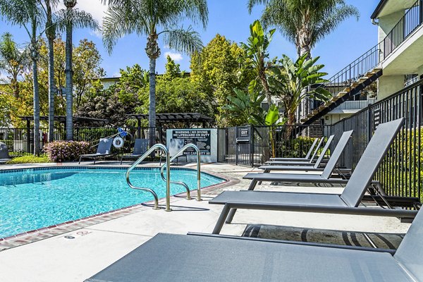 Outdoor swimming pool with cozy lounge chairs at Madrid Apartments, a Greystar luxury community in a vibrant neighborhood