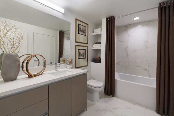 Altana Apartments: Modern bathroom with sleek fixtures and ample storage