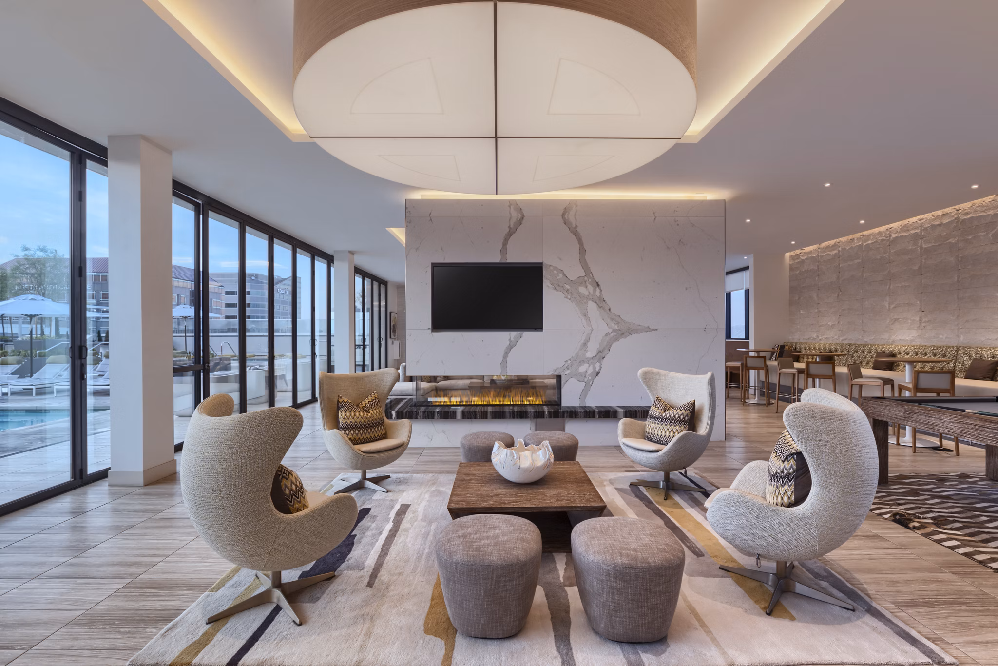 Clubhouse at Altana Apartments: Elegant modern design featuring plush seating and natural lighting