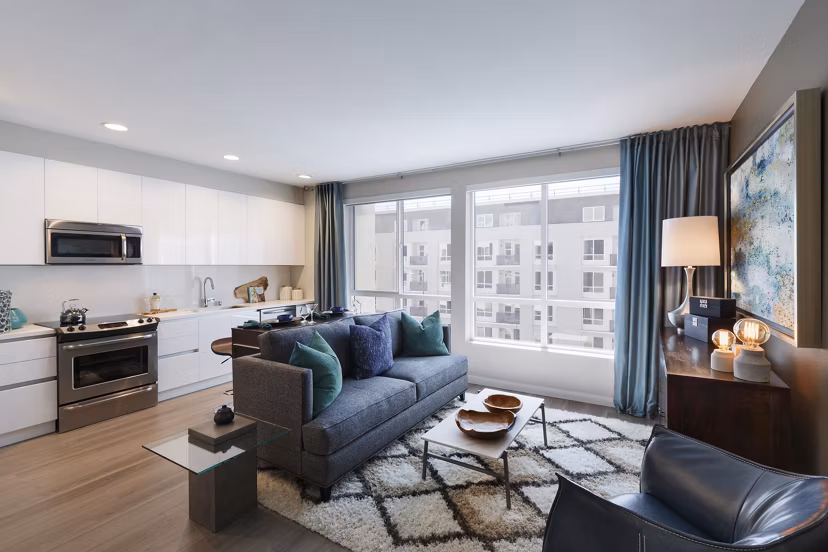 Modern living room with sleek furniture and vibrant decor at Altana Apartments