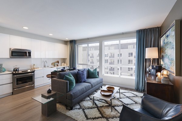 Modern living room with sleek furniture and vibrant decor at Altana Apartments