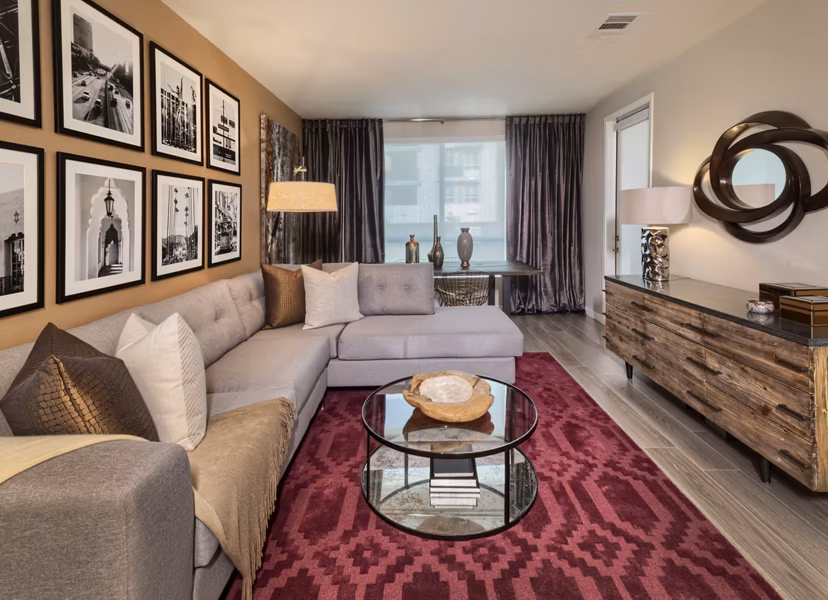Spacious living room with modern decor and expansive windows in Altana Apartments, offering luxury living at Greystar's premier location