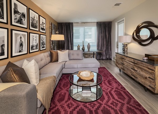 Spacious living room with modern decor and expansive windows in Altana Apartments, offering luxury living at Greystar's premier location
