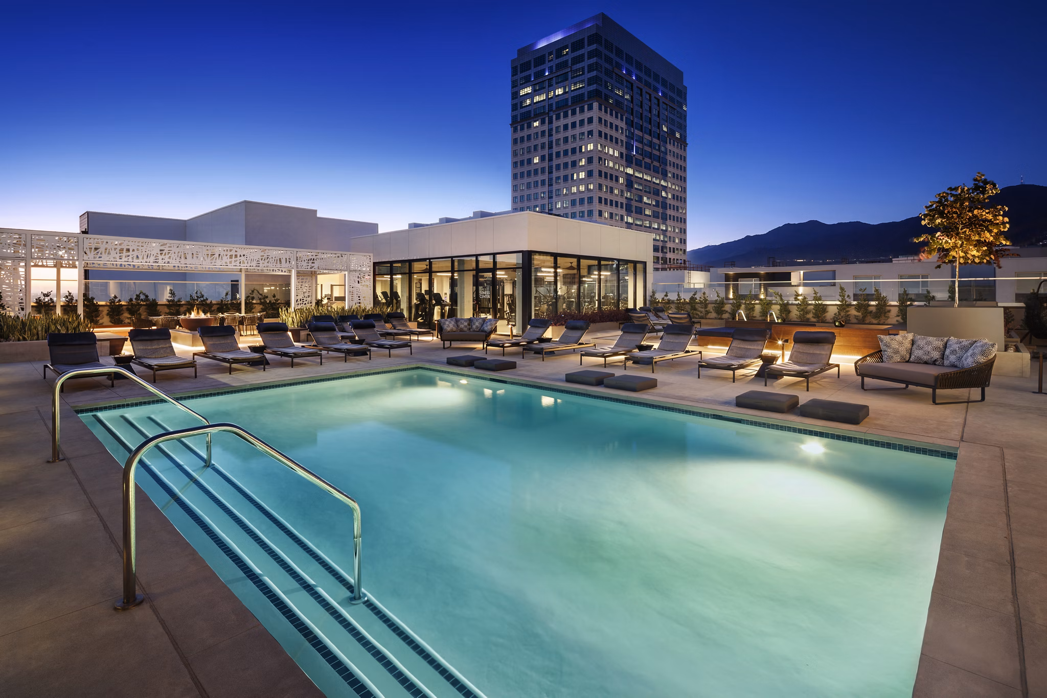 Altana Apartments: Luxury pool with lounge chairs and scenic views