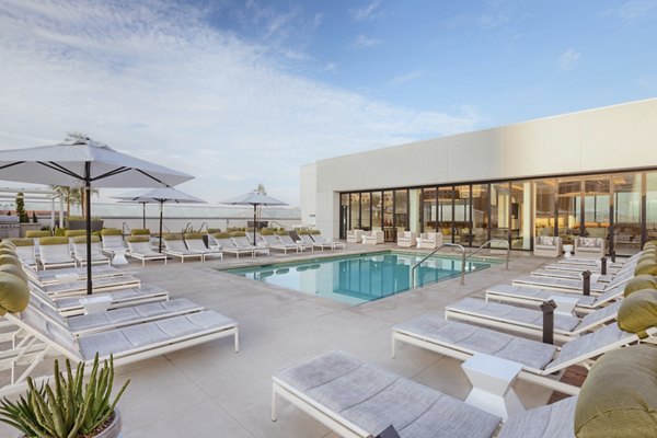 Luxurious pool with sun loungers at Altana Apartments, Glendale offering a relaxing retreat for residents
