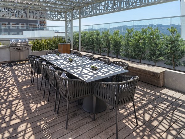 Outdoor grill area with modern seating at Altana Apartments offering leisure spaces for residents