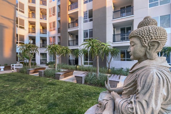 Altana Apartments: Lush courtyard with modern seating area and garden features at luxury community
