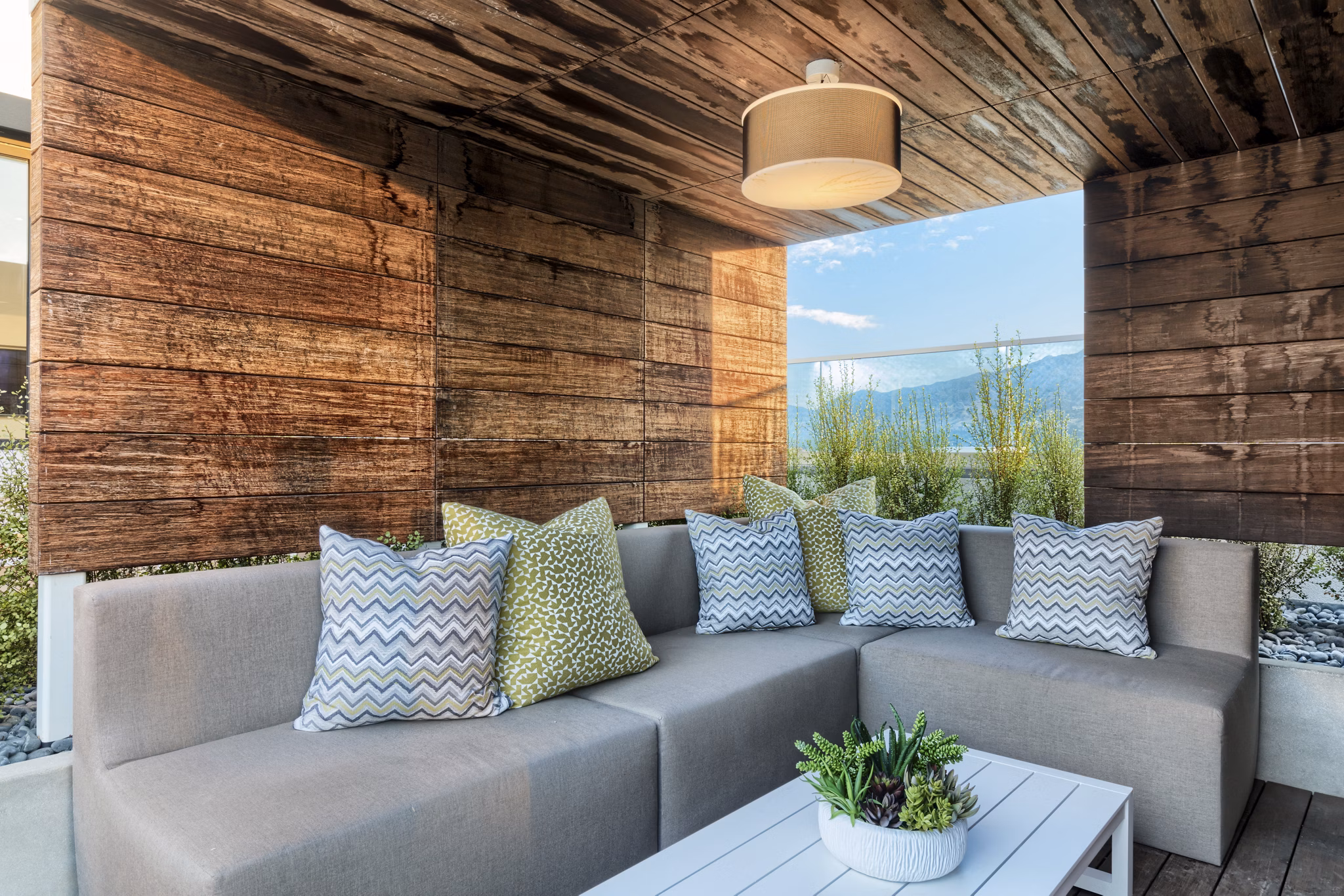 Cozy outdoor patio with modern furniture at Altana Apartments, perfect for relaxation and social gatherings