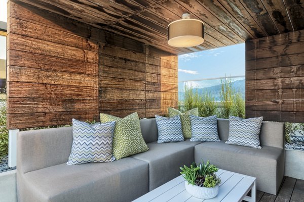 Cozy outdoor patio with modern furniture at Altana Apartments, perfect for relaxation and social gatherings