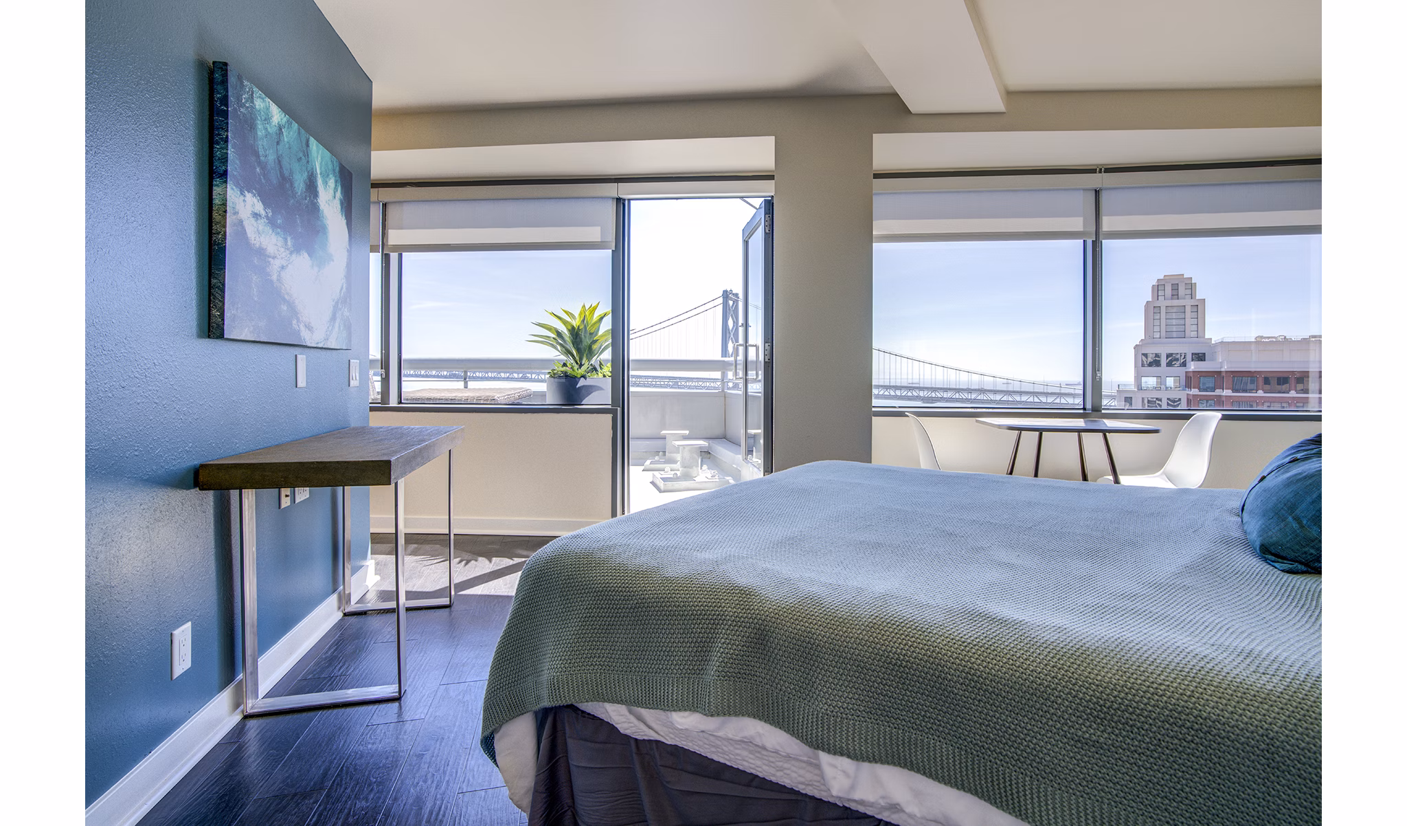 Bedroom featuring modern decor and city views at The Towers at Rincon Apartments
