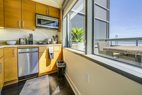 Modern kitchen with stainless steel appliances at The Towers at Rincon Apartments