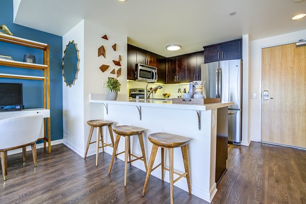 Modern kitchen with stainless steel appliances in The Towers at Rincon Apartments
