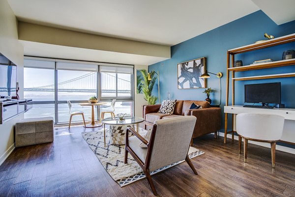 Modern living room with city views in The Towers at Rincon Apartments