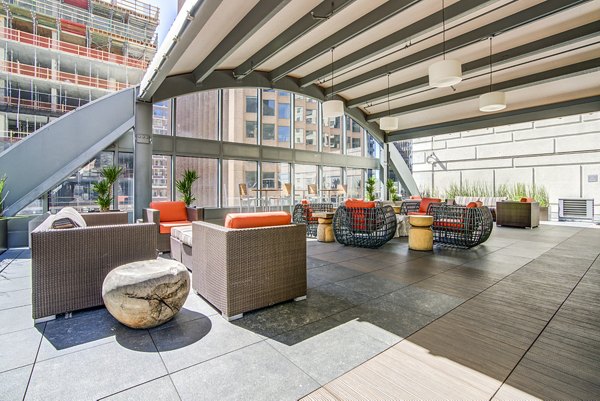 Clubhouse patio with cozy seating and fire pit at The Towers at Rincon Apartments in San Francisco