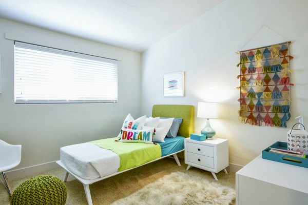 Cozy bedroom with modern decor at Arbors at Antelope Apartments featuring a luxury living experience
