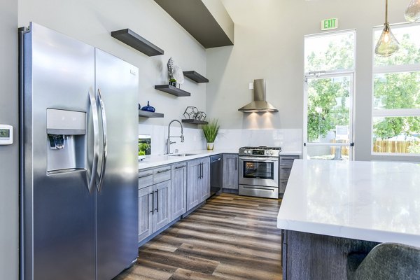 Modern clubhouse kitchen with stainless steel appliances at Arbors at Antelope Apartments, a Greystar luxury community