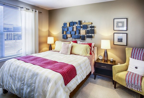 Modern bedroom with sleek furniture design at RockVue Apartments