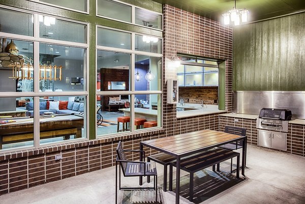 Grill area with outdoor seating at RockVue Apartments in luxury Greystar community