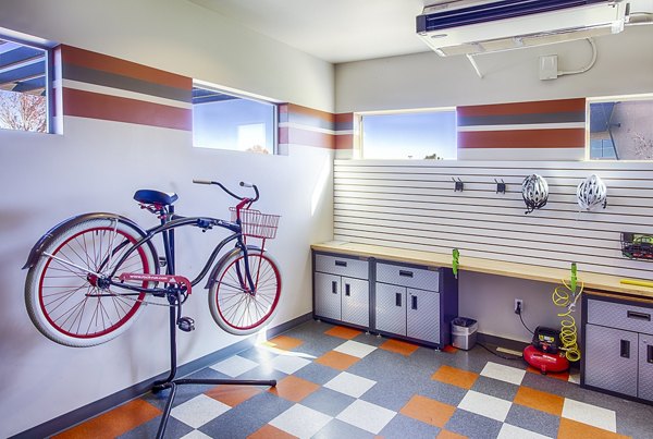 RockVue Apartments: Dedicated bike maintenance area with tools and stands for resident cyclists