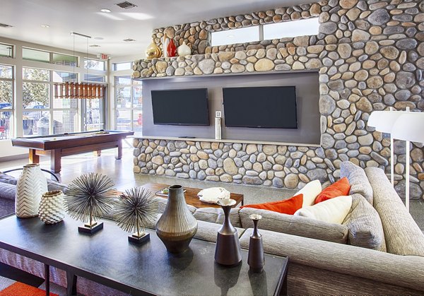 Modern game room with pool table and seating area at RockVue Apartments