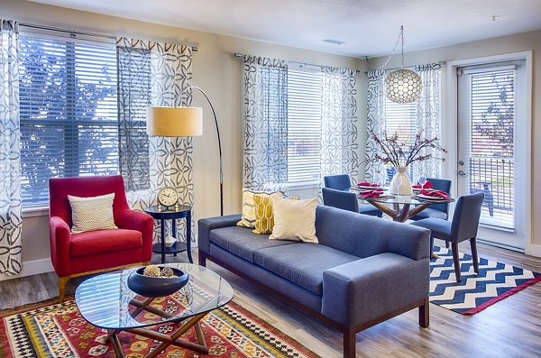 Living room at RockVue Apartments featuring modern furnishings and ample natural light, luxury apartments in a desirable location