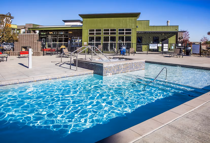 Resort-style pool with lounge seating at RockVue Apartments, offering luxury living