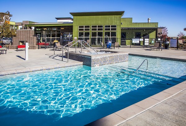 Resort-style pool with lounge seating at RockVue Apartments, offering luxury living