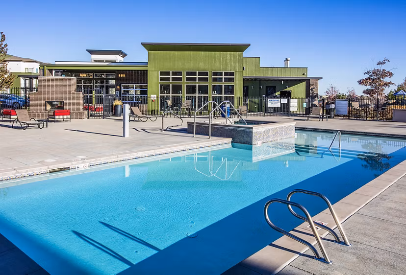 Resort-style pool with lounge chairs at RockVue Apartments, showcasing luxury living in a prime location