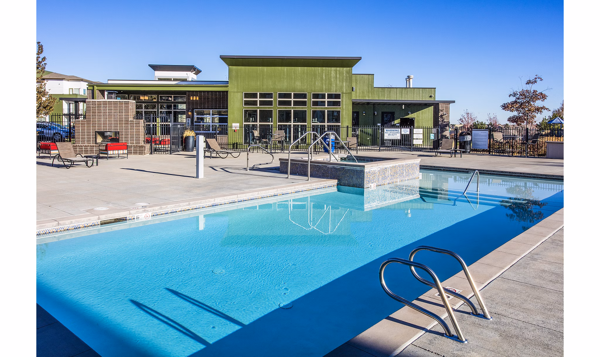 Resort-style pool with lounge chairs at RockVue Apartments, showcasing luxury living in a prime location
