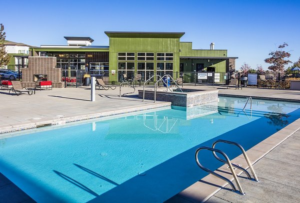Resort-style pool with lounge chairs at RockVue Apartments, showcasing luxury living in a prime location