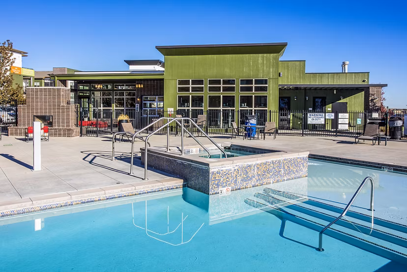 Luxurious pool area at RockVue Apartments with lounge seating and mountain views