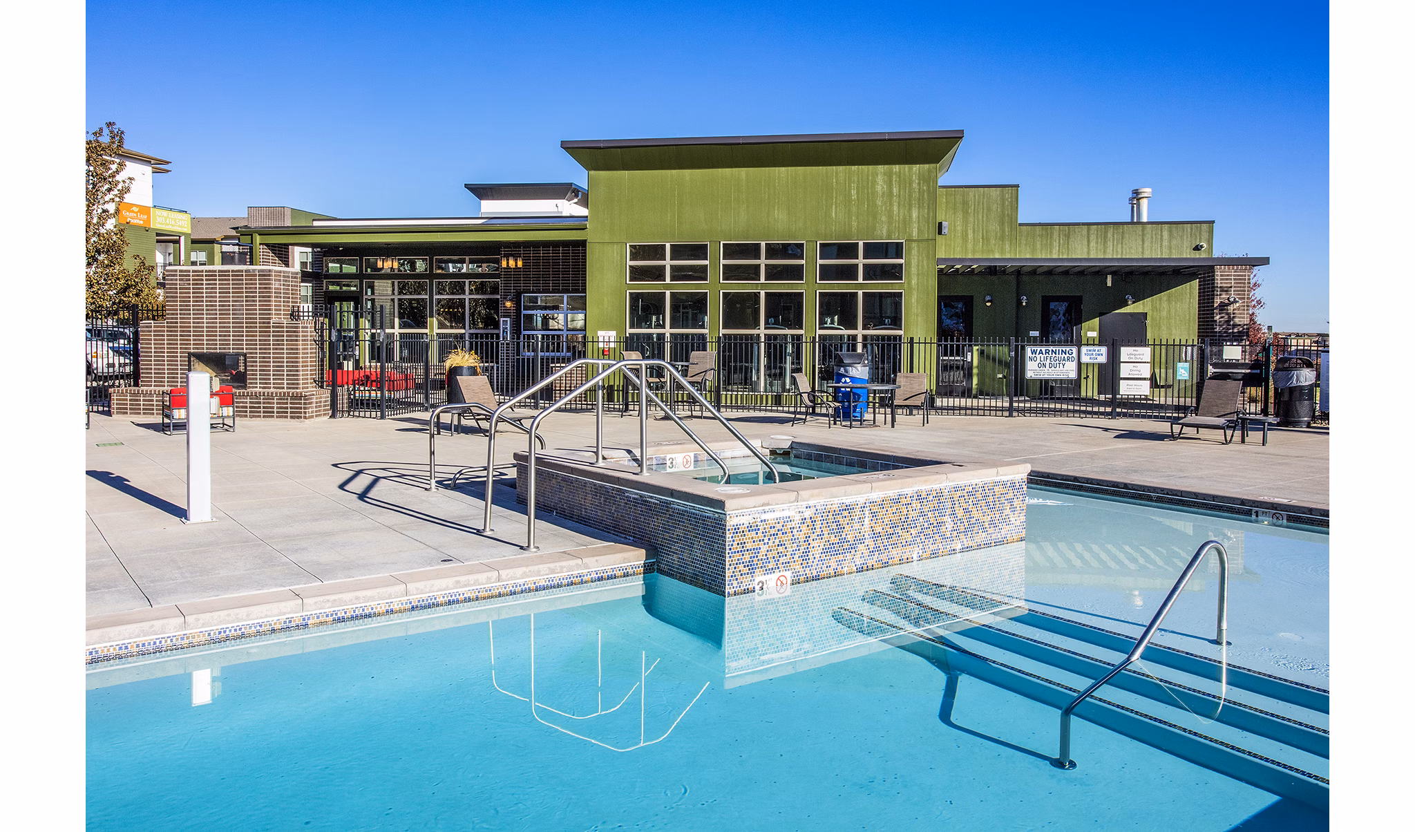 Luxurious pool area at RockVue Apartments with lounge seating and mountain views