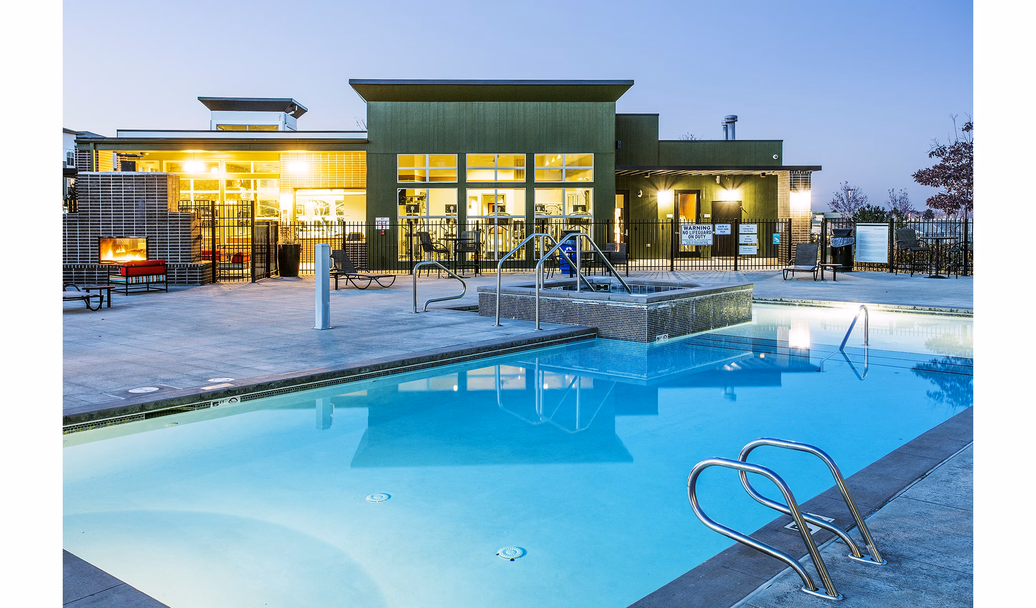 Luxurious pool area with lounge chairs at RockVue Apartments in Colorado, providing a relaxing retreat for residents