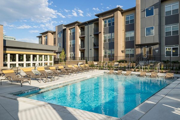Poolside relaxation at Pearl DTC Apartments featuring a luxury pool area surrounded by stylish loungers and lush landscaping