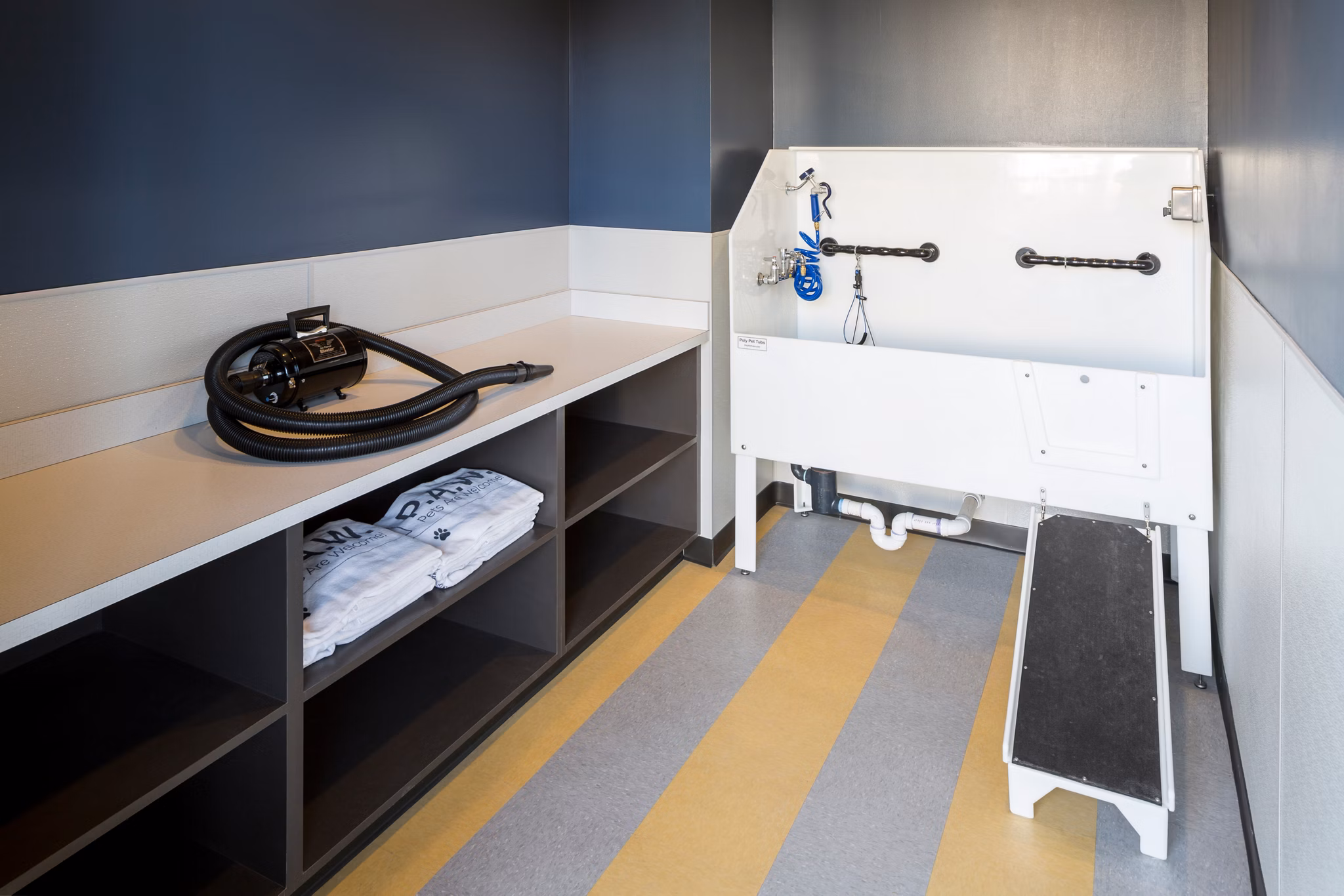 Dog wash station with stainless steel fixtures at Pearl DTC Apartments, a luxury community offering pet-friendly amenities