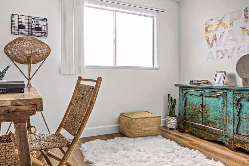 Bedroom with home office space at Kapilina Beach Homes Apartments, featuring coastal-inspired decor and natural light