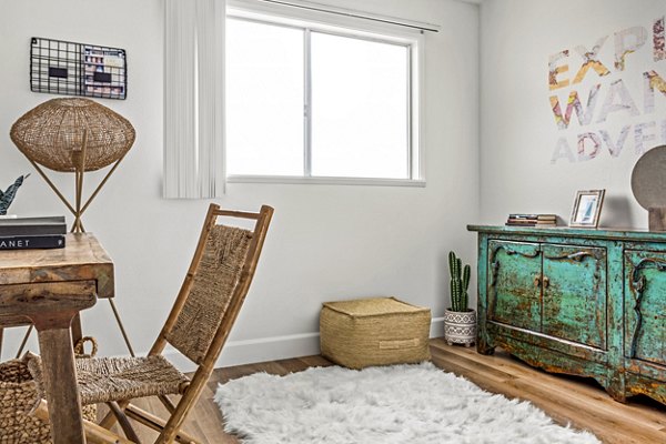 Bedroom with home office space at Kapilina Beach Homes Apartments, featuring coastal-inspired decor and natural light